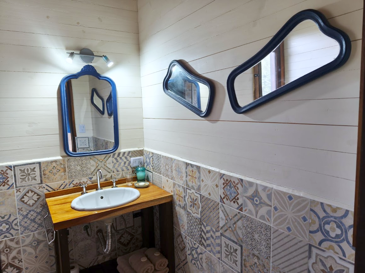 Bacha y espejos antiguos en el baño de la Cabaña Chuña 1