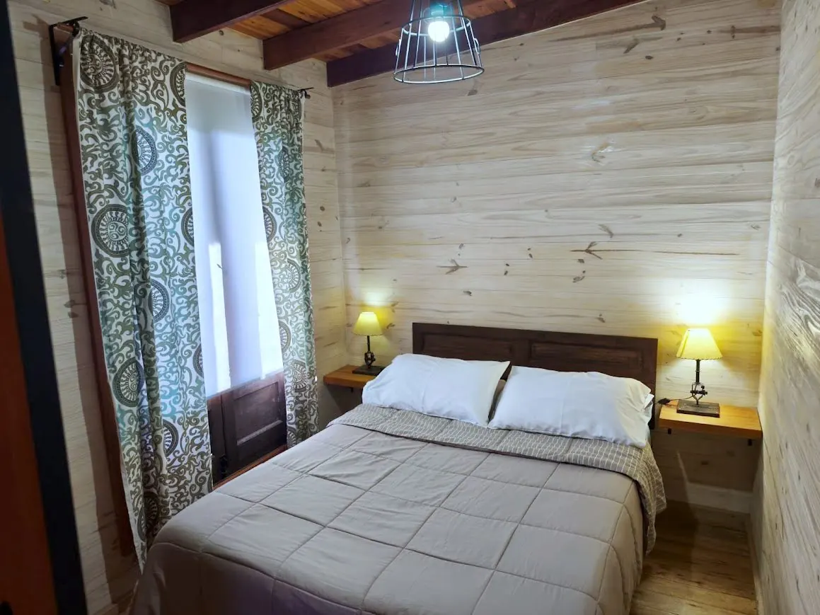 Dormitorio de la Cabaña Chuña 2 con cama matrimonial y ropa blanca incluida